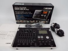 BOSS - A boxed Boss BR-800 digital recorder.