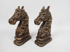 A pair of bronzed, cast iron, book ends in the form of horse heads, approximately 23 cm (h),