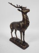 A bronzed, cast iron figure depicting a stag, approximately 29 cm (h),