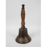A cast iron hand bell with wooden handle, 29 cm,