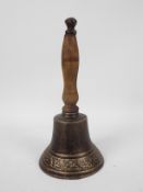 A cast iron hand bell with wooden handle, 29 cm,