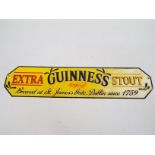 A cast iron wall plaque marked Guinness Extra Stout, 13 cm x 56 cm,