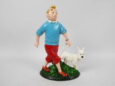 A cast iron doorstop in the form of Tintin and Snowy, approximately 33 cm (h),