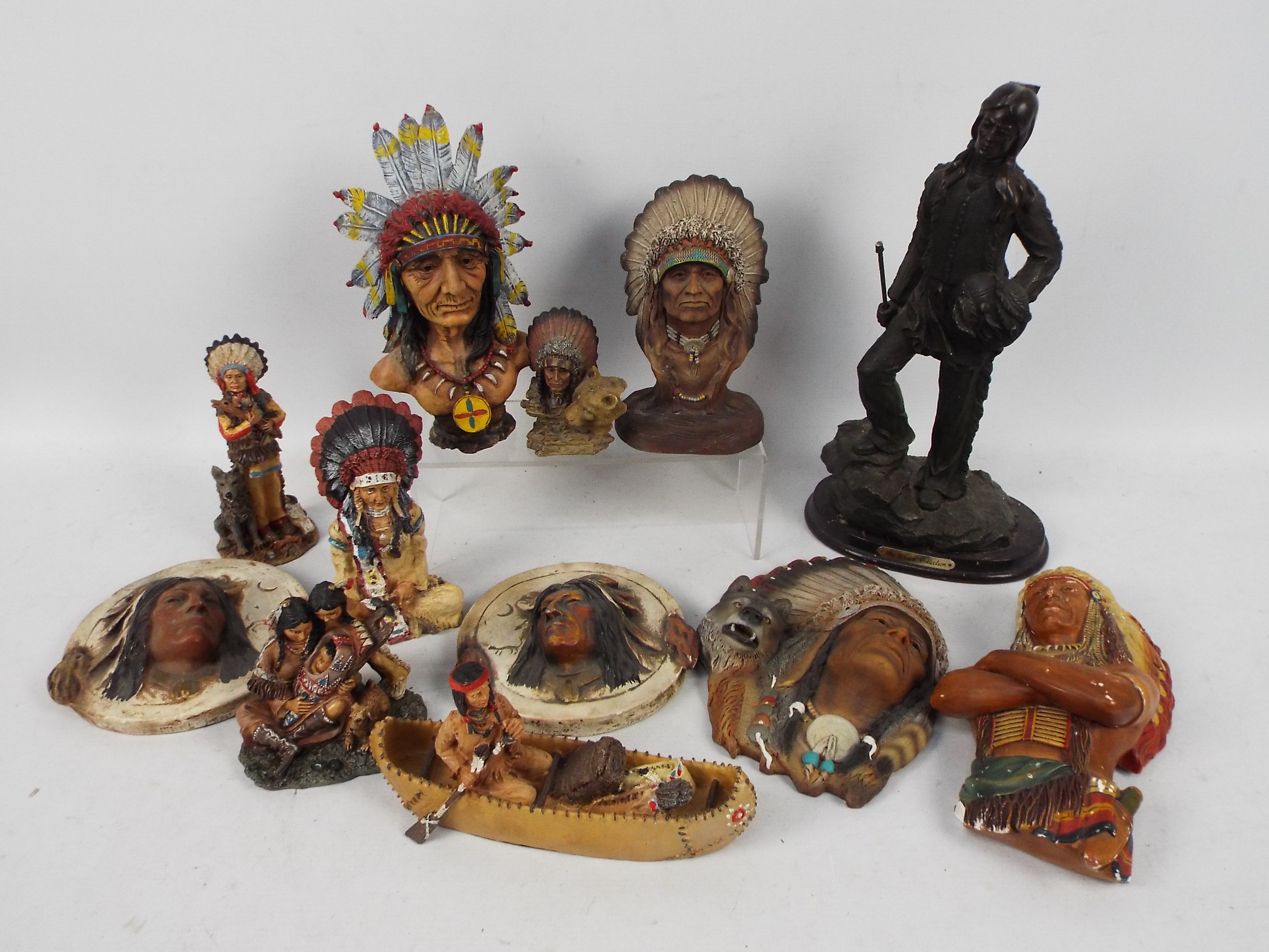A collection of Native American themed ornaments and wall art, largest approximately 33 cm (h).