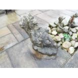 Garden ornament - a reconstituted stoneware figure depicting a seated gentleman,