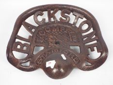 A cast iron tractor seat marked Blacksto