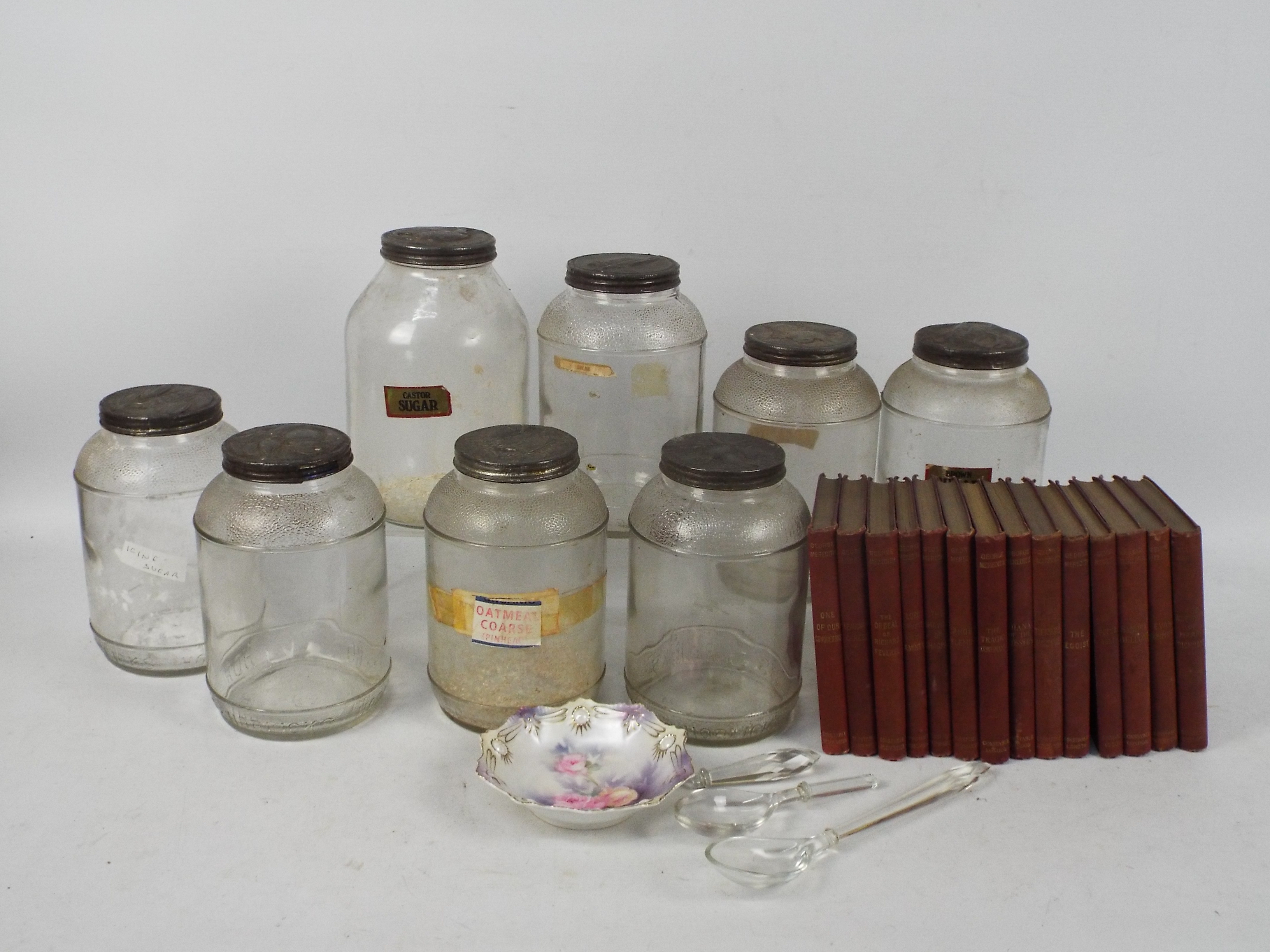 A collection of works by George Meredith, glass kitchen storage jars and other.