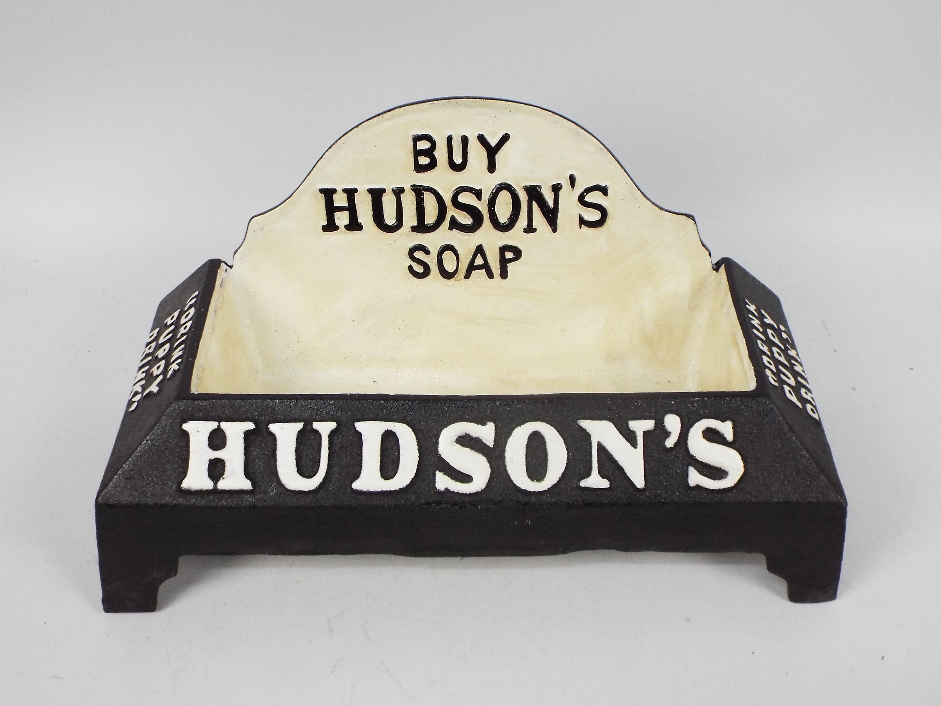 A cast iron water bowl marked Hudson's S