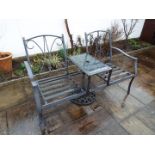 A garden table flanked by twin seats,