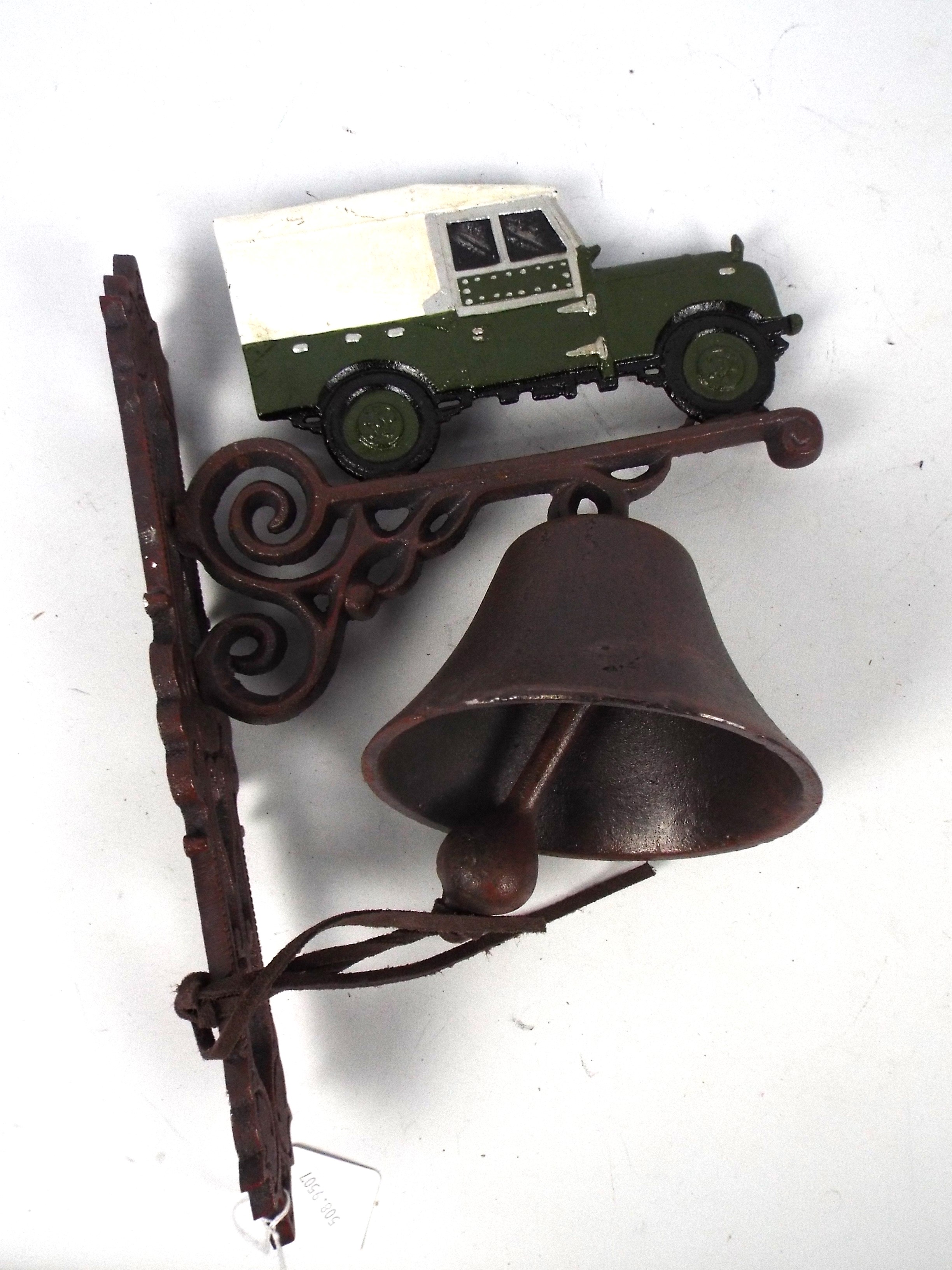 A wall mountable, cast iron bell with La