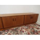 G Plan Furniture - a teak low chest of twin cupboards, 54 cm x 162 cm x 45 cm,