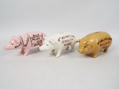 Three cast iron pig money banks, approxi