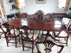 A twin pedestal, extending dining table with six dining chairs and two carvers,