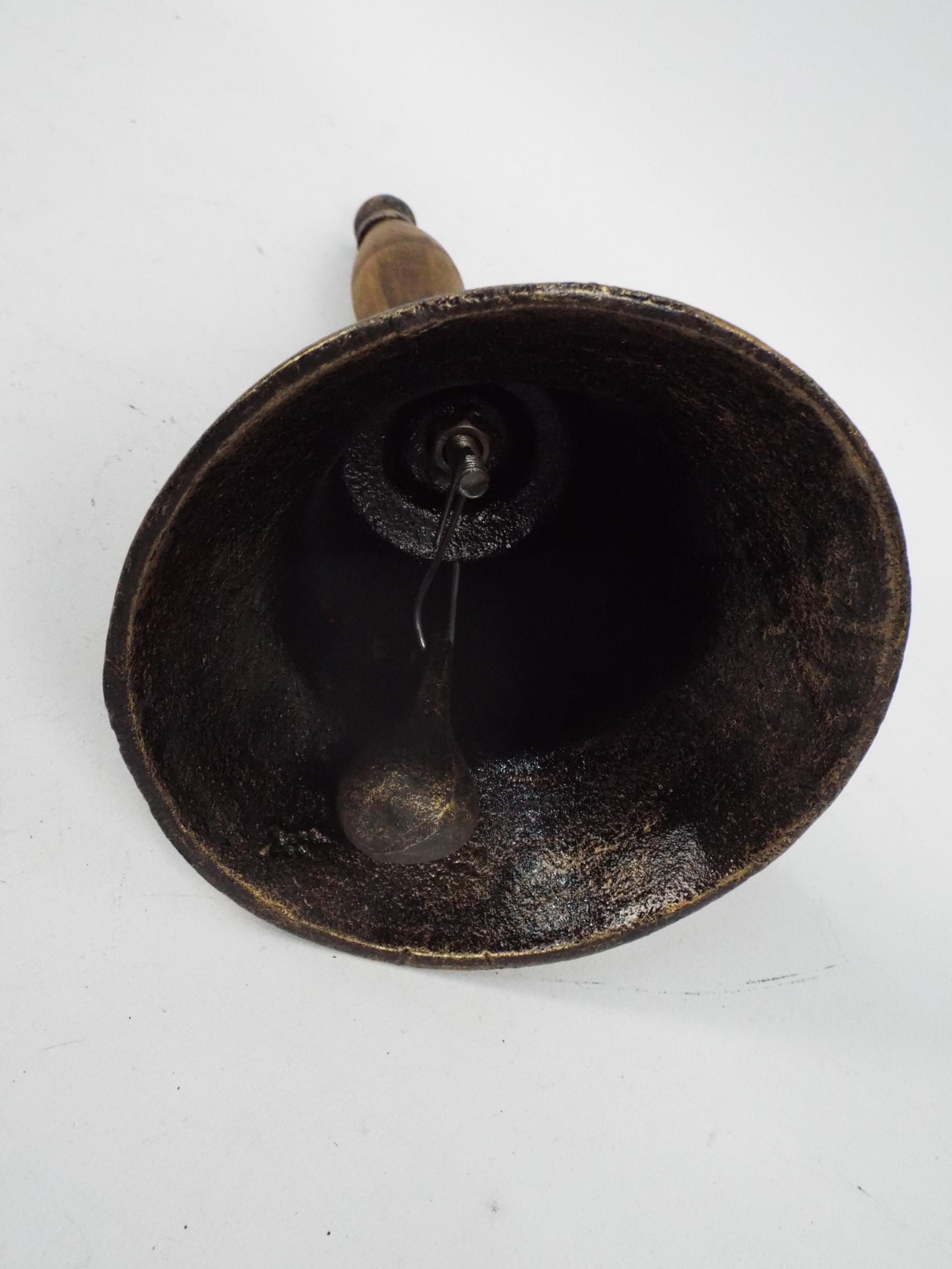 A cast iron hand bell with wooden handle - Image 2 of 2