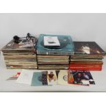 A collection of 12" vinyl records to include Status Quo, Elton John, The Carpenters, ABBA,