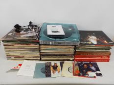 A collection of 12" vinyl records to include Status Quo, Elton John, The Carpenters, ABBA,