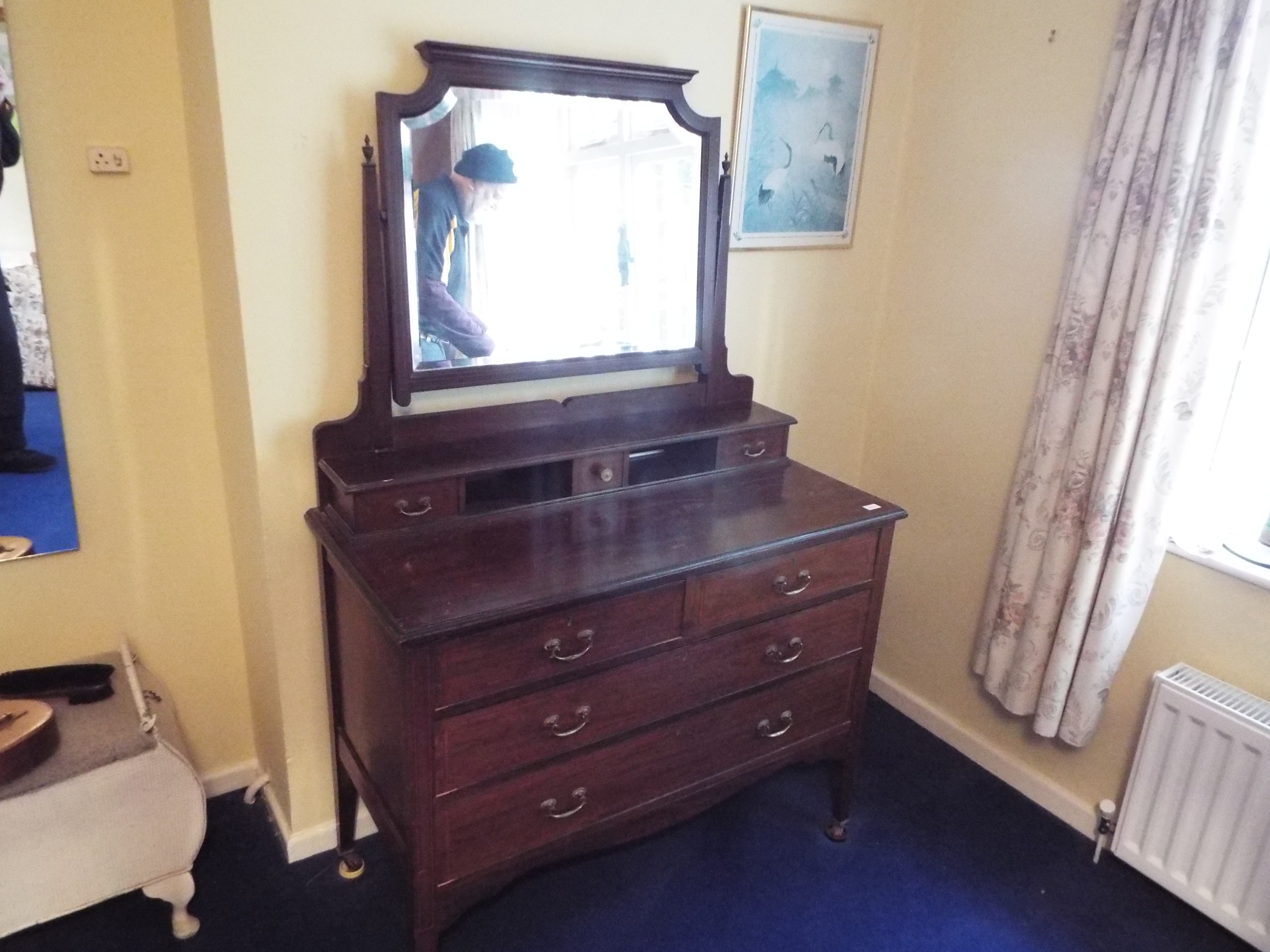 A vanity chest of two over two drawers with mirror back, approximately 165 cm x 108 cm x 54 cm.