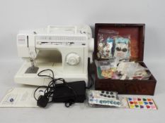A Singer sewing machine and a box of hab