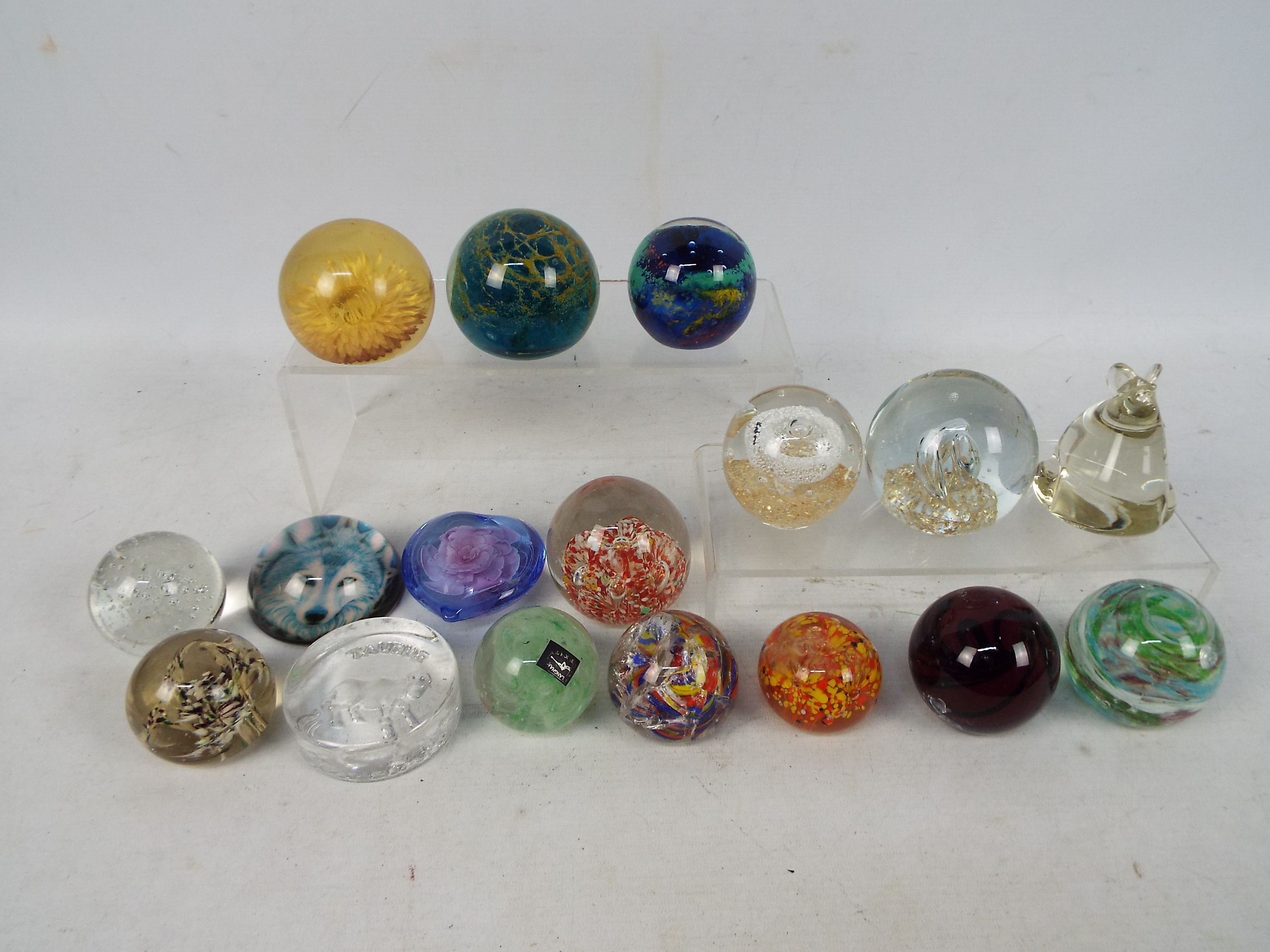 A collection of paperweights to include Mdina, Langham Glass and other.