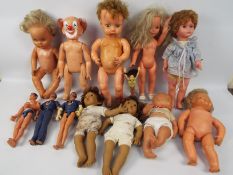 A collection of vintage dolls and action figures to include Tiny Tears, Action Man and similar.