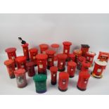 A collection of Post Office pillar box models and money banks to include ceramic and tin examples.