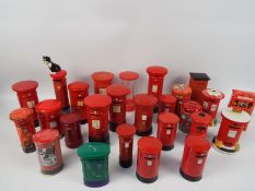 A collection of Post Office pillar box models and money banks to include ceramic and tin examples.