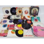 A quantity of 7" vinyl records to include The Rolling Stones, ABBA, The Carpenters, The Sweet,