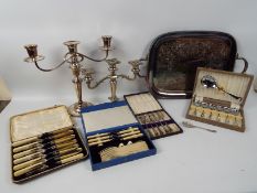 A quantity of plated ware to include twin handled tray, candelabra,