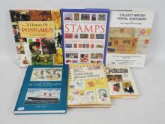 A group of reference books relating to deltiology and philately.