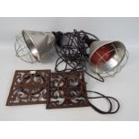 A pair of vintage infra red heat lamps and a pair of cast iron, wall mountable flowerpot holders.