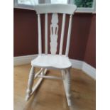 A traditional style, white painted rocking chair.