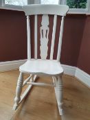 A traditional style, white painted rocking chair.