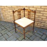 An Edwardian marquetry inlaid corner chair with upholstered seat, retailed by Jones & Higgins Ltd,