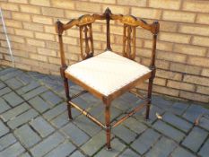 An Edwardian marquetry inlaid corner chair with upholstered seat, retailed by Jones & Higgins Ltd,