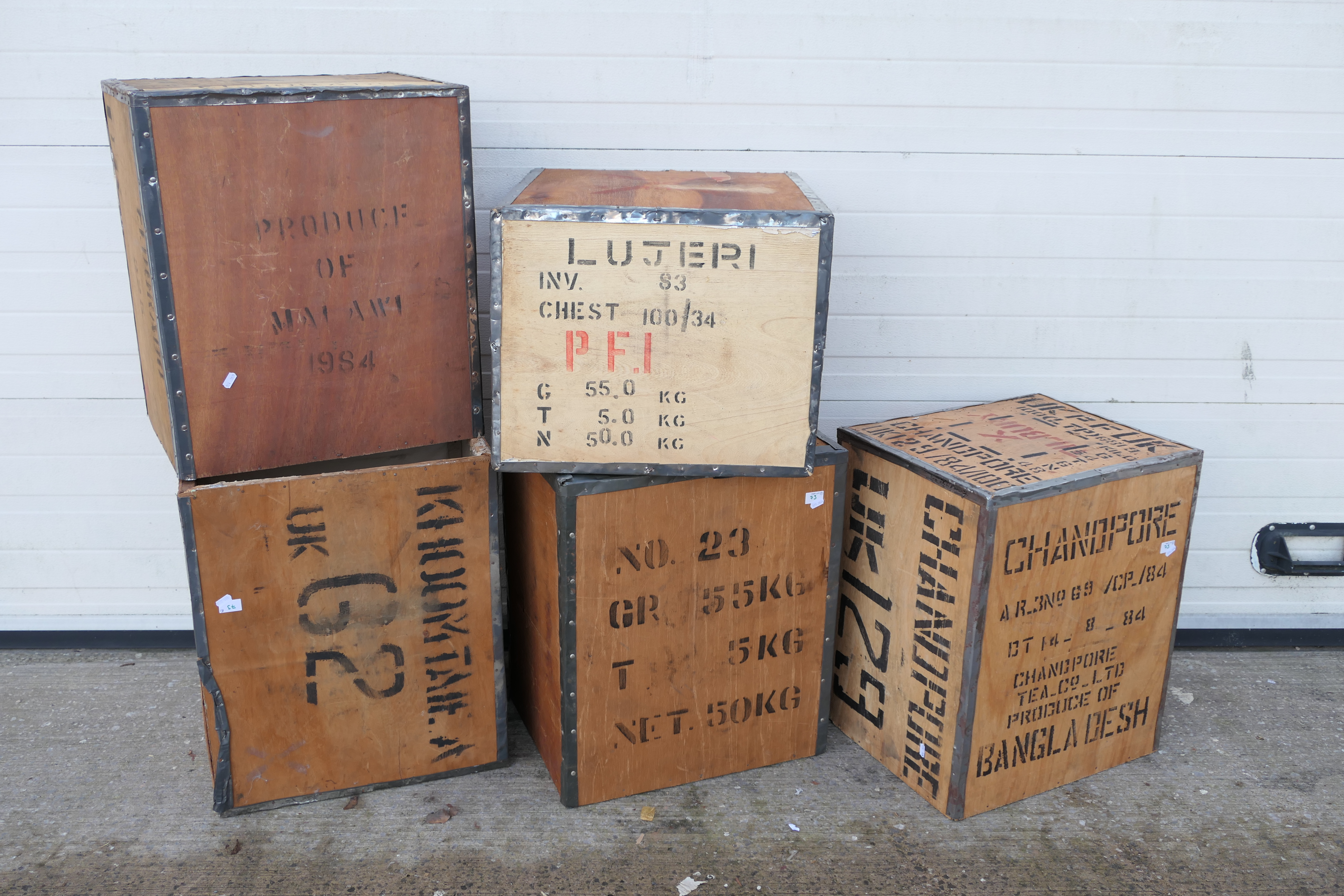 Five vintage metal bound, wooden tea chests, each approximately 60 cm x 50 cm x 40 cm.