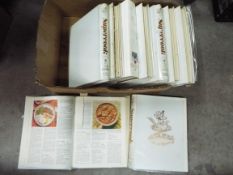 A collection of recipe books and an AA motor tour guide.