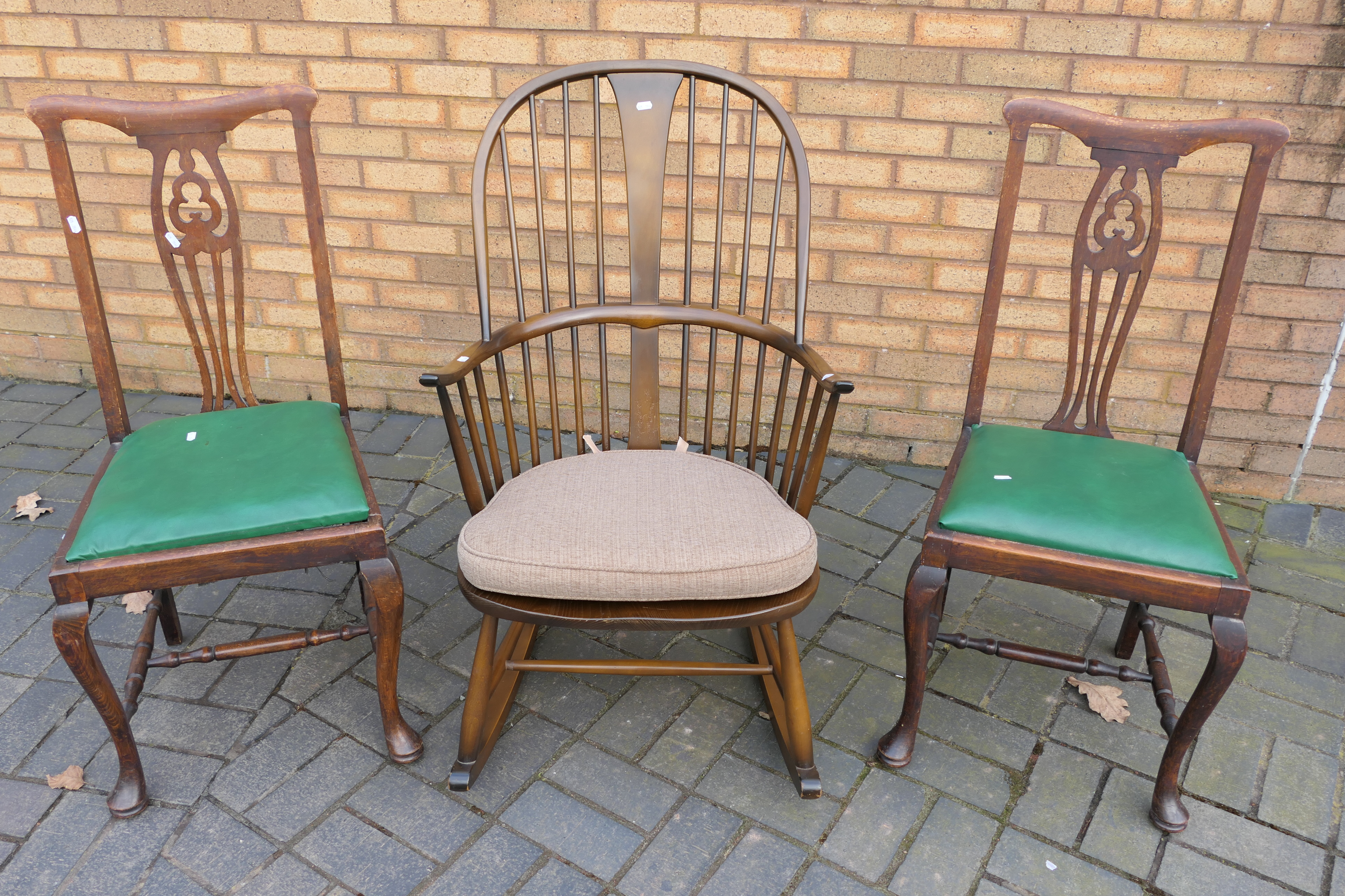 Ercol - An Ercol Chairmakers Windsor rocking chair (gold label) and two dining chairs.