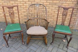 Ercol - An Ercol Chairmakers Windsor rocking chair (gold label) and two dining chairs.