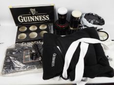 Guinness - Various Guinness branded collectables to include bar top covers, drip trays, inflatables,