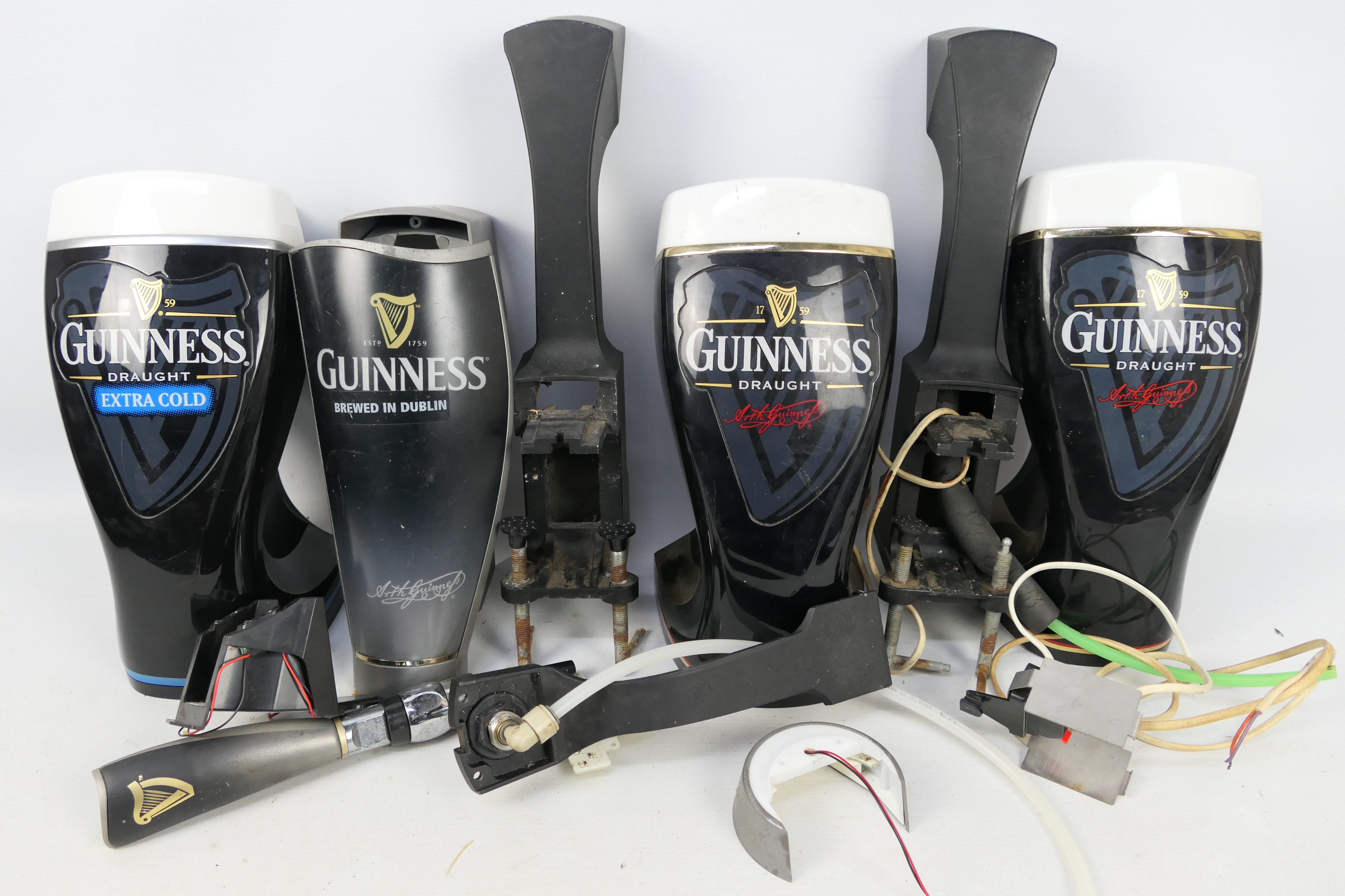 Guinness - Three Guinness bar top pump covers.