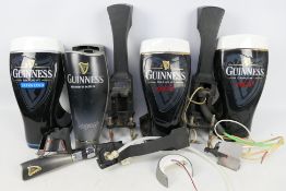 Guinness - Three Guinness bar top pump covers.