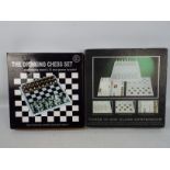A 3 in 1 glass games compendium and a glass shot glass chess set, both boxed.