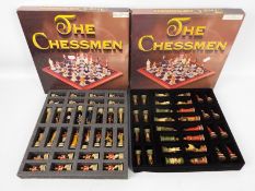 Two boxed sets of The Chessmen chess pie