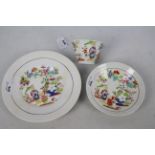 A cup, saucer and plate decorated with