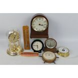 A collection of clocks and thermometers