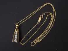 A 9ct yellow gold pendant set with five