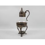 A glass and silver plate coffee pot with