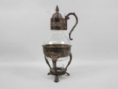 A glass and silver plate coffee pot with