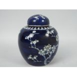 A blue and white ginger jar and cover, decorated in prunus, vacant double circle mark to the base,