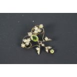 A yellow metal, peridot and seed pearl pendant / brooch, unmarked (presumed 9ct), approximately 3.